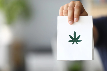 a card with a marijuana leaf on it